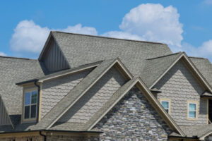 an asphalt shingle roof on a home with many gables